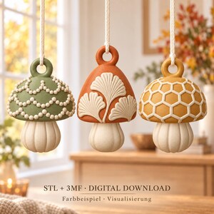 May include: Three hanging mushroom ornaments with white rope loops. The left is sage green with beaded scalloped patterns, the center is terracotta with embossed ginkgo leaves, and the right is mustard yellow with a honeycomb grid. Text: STL + 3MF DIGITAL DOWNLOAD.