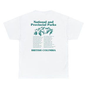 May include: White t-shirt with a teal graphic featuring the text "National and Provincial Parks" above a mountain and tree illustration. Below, the text "British Columbia" is printed. A list of parks is printed below the mountain graphic.