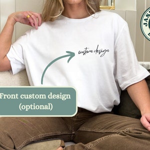 May include: White t-shirt with the words "custom design" in black script. An arrow points from the text to the front of the shirt. The shirt is part of the Jasper Peak Designs collection. The words "Front custom design (optional)" are in a green box.