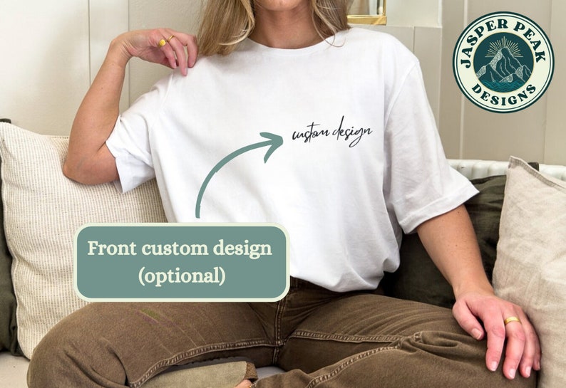 May include: White t-shirt with the words "custom design" in black script. An arrow points from the text to the front of the shirt. The shirt is part of the Jasper Peak Designs collection. The words "Front custom design (optional)" are in a green box.
