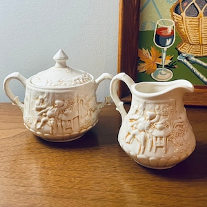 The Witches Persuit Lidded Sugar Bowl and Creamer in Cream and Golden Amber Folk Pattern