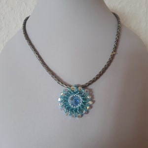 Hand-threaded pendant made of Miyuki and Swarovski beads on a silver-colored leather strap