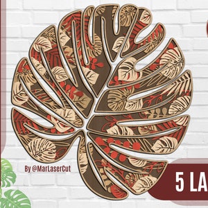 Puede incluir: Un diseño de hoja de monstera de madera en capas con un contorno marrón, relleno con patrones de hojas de color canela, rojo y marrón. El texto "CUTTING FILE" y las abreviaturas de los tipos de archivo están a la izquierda. El texto "5 LAYERS" está en la parte inferior.