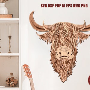 May include: A digital file for laser cutting a Highland Cow head design. The design is made up of intricate layers of wood, creating a 3D effect. The cow's face is detailed with a brown nose, white markings, and a long, flowing mane.