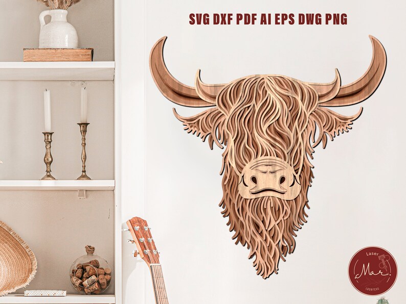 May include: A digital file for laser cutting a Highland Cow head design. The design is made up of intricate layers of wood, creating a 3D effect. The cow's face is detailed with a brown nose, white markings, and a long, flowing mane.