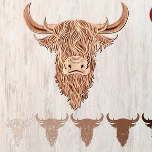 May include: A wooden cutout of a Highland cow head with a shaggy mane and long horns. The cutout is in a light brown color and has a detailed design. The image also shows five different variations of the cutout in different colors.