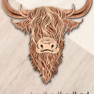 May include: Multilayer laser cut file of a Highland cow head with a brown wood finish. The file is available in SVG, DXF, PDF, AI, EPS, DWG, and PNG formats.