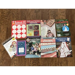 May include: A collection of nine instructional books and magazines focused on quilting and embroidery techniques, featuring titles such as Redwork 101, Embroidery Machine Essentials, Binding Basics and Beyond, America Sews, and Sunbonnet Sue in Redwork.