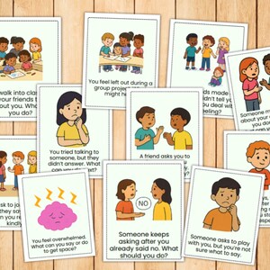 May include: A collection of illustrated cards with scenarios and questions about social situations. The cards feature cartoon children and text prompts like "You feel left out" and "Someone makes a joke." The cards are on a wooden surface.