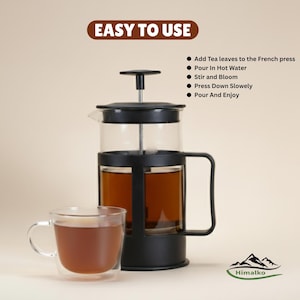May include: A black French press with a glass carafe, filled with tea, and a clear glass mug. The image includes the text "EASY TO USE" and instructions for use. The Himalko logo is in the bottom right corner.