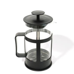 May include: A glass French press coffee maker featuring a black plastic frame, a black handle, and a matching black lid with a central plunger knob. The clear glass carafe is held within the black structure, which includes a base and a top rim.