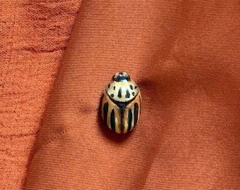 Striped gold beetle pin in polymer and resin