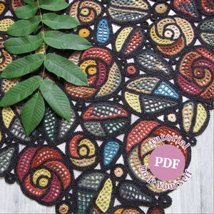 May include: A colorful crochet doily with a black background and a variety of geometric shapes and floral designs. The doily is surrounded by a green leaf and a pink circle with the text "Tutorial PDF Do It Yourself".