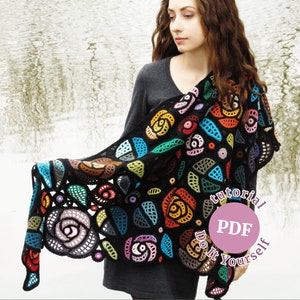 May include: A black crochet shawl with colorful flowers and leaves. The shawl is draped over a person's shoulders. The text "tutorial PDF Do It Yourself" is on a pink circle.