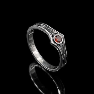 Feel the power of bold self-expression with this sterling silver garnet ring, featuring intricate gothic etching and a fiery red center stone. Handcrafted for the modern alchemist, rebel, or romantic, this piece merges strength with symbolism — the deep red garnet evokes passion, protection, and purpose.