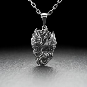 Introducing our stunning Silver Phoenix Pendant! Handcrafted with the finest quality sterling silver, this piece is sure to impress. The intricate design showcases a beautifully detailed phoenix, symbolizing strength, renewal, and rebirth.