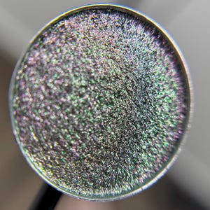 Fangs is a hand pressed multichrome shimmer 26mm single eyeshadow topper