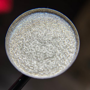 925 is a hand pressed shimmer 26mm single eyeshadow topper