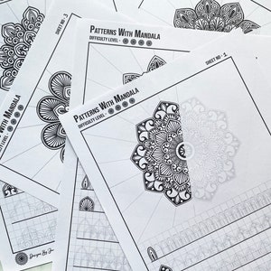 May include: A stack of white paper sheets featuring intricate black and white mandala patterns for coloring. The sheets are labeled "Patterns With Mandala" with varying difficulty levels. The design includes the text "Designs By Jayshree".