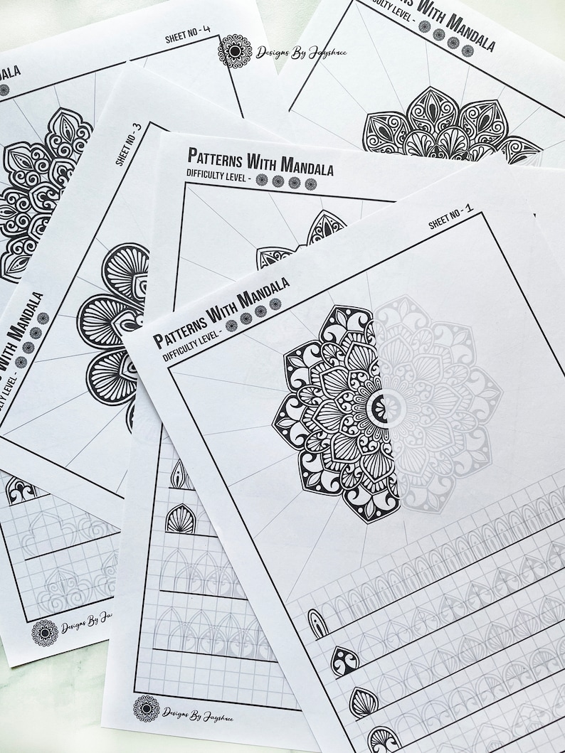 May include: A stack of white paper sheets featuring intricate black and white mandala patterns for coloring. The sheets are labeled "Patterns With Mandala" with varying difficulty levels. The design includes the text "Designs By Jayshree".