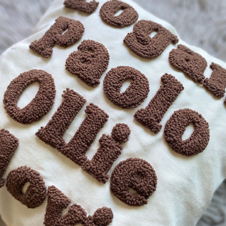 May include: A white pillow with the words "You are my Ollie" in brown puffy letters.