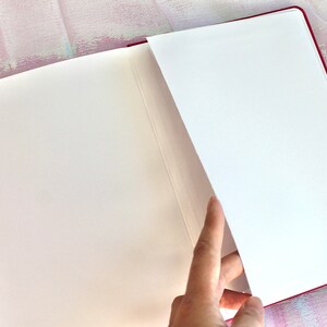 Dot Grid Journal, Dot Grid Journal, Travel Journal, Reading Journal, Journals and Notebooks, Junk Journal, Dot Grid Notebook, Halloween Gift. A pink notebook with white pages. The notebook is open and the pages are fanned out. The notebook has a ribbon bookmark.