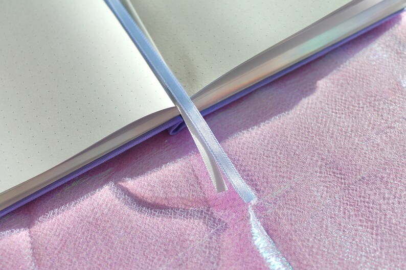 A purple notebook with a white ribbon bookmark. The notebook is open and the pages are blank with small dots. Dot Grid Journal, Dot Grid Journal, Travel Journal, Reading Journal, Journals and Notebooks, Junk Journal, Dot Grid Notebook, Halloween Gift
