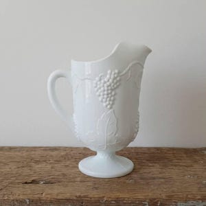 May include: A set of three ceramic mugs with a speckled, matte finish. The mugs are in shades of cream, light gray, and dark gray. Each mug has a simple, minimalist design, perfect for coffee or tea.