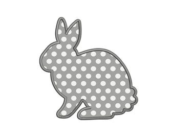May include: A gray rabbit silhouette with a white polka dot pattern. The rabbit is sitting with its ears up.