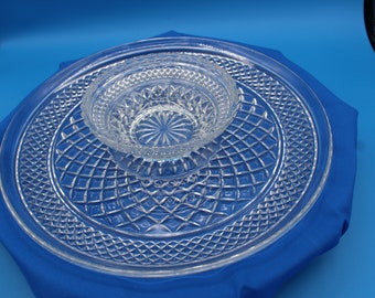 May include: A clear glass serving tray with a smaller bowl in the centre. Both pieces have a diamond pattern.