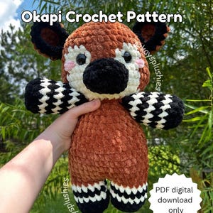 May include: Crochet pattern for a brown and black Okapi plush toy. The pattern is available as a digital PDF download only. The plush toy is holding a sign that says "PDF digital download only".