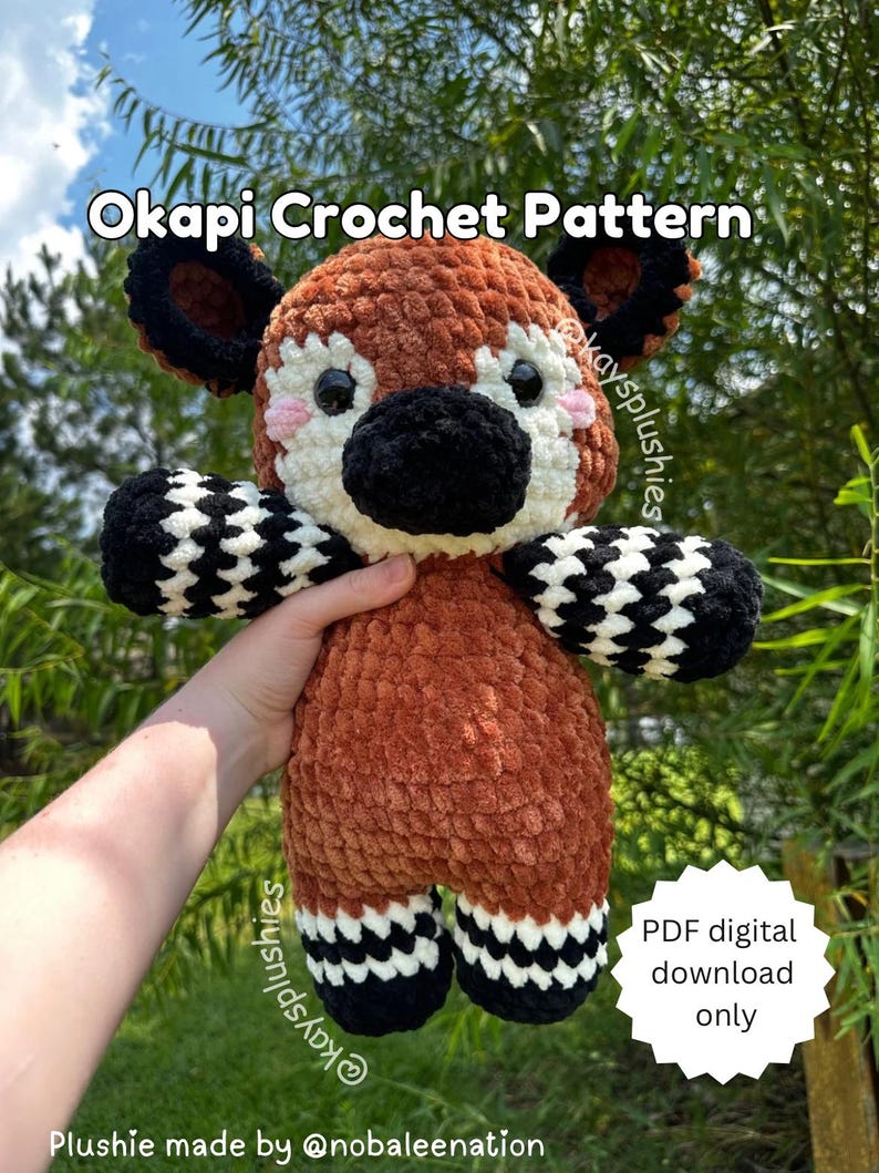 May include: Crochet pattern for a brown and black Okapi plush toy. The pattern is available as a digital PDF download only. The plush toy is holding a sign that says "PDF digital download only".