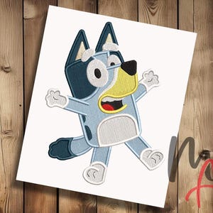 May include: An embroidery design featuring a light blue and dark blue cartoon dog character with large white eyes, a black nose, and a yellow muzzle. The character is depicted in a dynamic pose with arms outstretched, white paws, and a white belly patch.