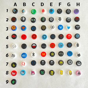 May include: A set of 9 rows of 8 colorful round buttons with various designs. The buttons are arranged in a grid pattern. The designs include a variety of characters, logos, and symbols.