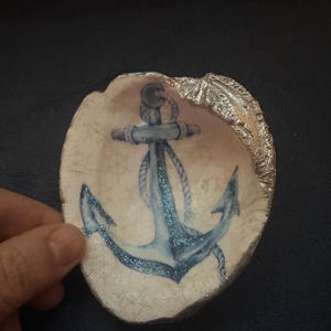 The sea is my love!  Handmade with real seashell showing anchor themed trinket dish with added chrome color and sparkle on the anchor.