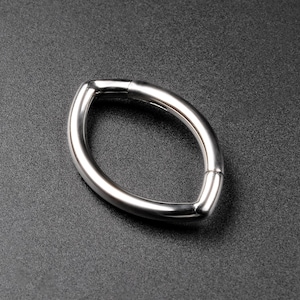 May include: A polished, silver-colored oval-shaped metal ring. The ring has a smooth, reflective surface and a seamless design, with a small gap at one point. The ring is set against a dark gray background.