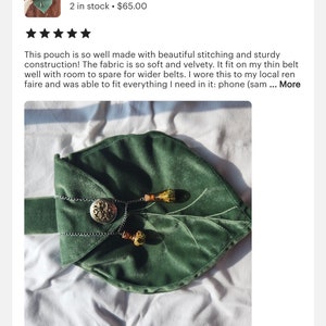 May include: A green velvet leaf-shaped pouch with a silver clasp and two decorative tassels. The pouch is lying on a white surface.
