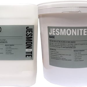 May include: Two white plastic containers of Jesmonite AC100 liquids and Jesmonite base. The containers are labeled with product information and mixing instructions. The containers are made from Jesmonite.