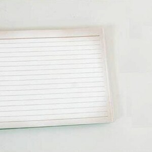 May include: A white spiral bound notebook with lined pages.