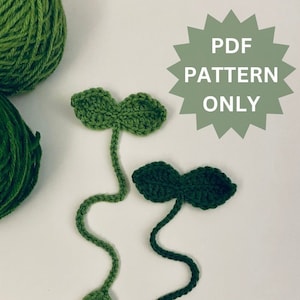 May include: Two green crocheted plant bookmarks with a stem and leaves. The text "PDF PATTERN ONLY" is in a green starburst shape.