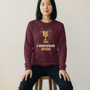 I Survived 2026 Trophy Tee, Funny Battered Trophy Shirt, We Made It Top Bild 7