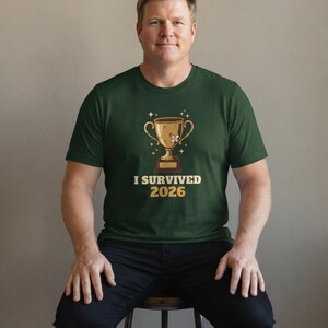 I Survived 2026 Trophy Tee, Funny Battered Trophy Shirt, We Made It Top Bild 4