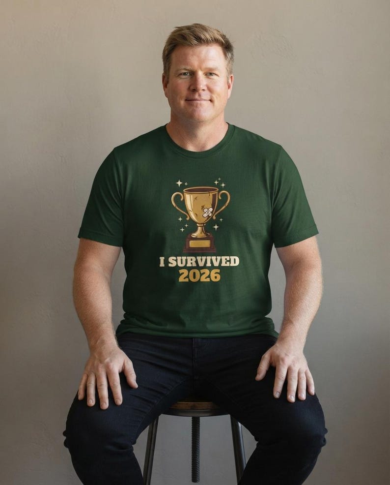 I Survived 2026 Trophy Tee, Funny Battered Trophy Shirt, We Made It Top Bild 4