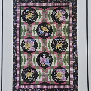 May include: A printed pattern for a "Sew Classy" quilt, featuring floral designs in black, pink, green, and yellow. The quilt pattern is for lap, twin, full, queen, and king sizes. The lap quilt size is 54" W x 79" L.
