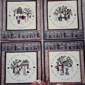 May include: A quilt pattern set titled Bushels of Joy by Carol Endres Collection featuring four square panels with embroidered scenes of people, trees, and fruit, surrounded by borders of figures, with text including The Seeds of Love Bring Bushels of Joy.