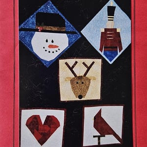 May include: A paper piecing pattern sheet with a red border and black background. It features five 8-inch square block designs: a snowman, a toy soldier, a reindeer, a heart, and a cardinal bird. Text at the top reads "PAPER PIECING FOR FUN".
