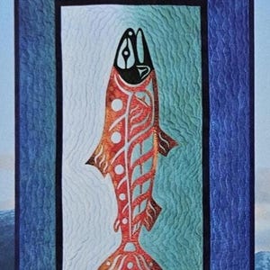 May include: A quilted wall hanging featuring two stylized salmon in shades of red and orange, with black accents. The fish are set against a backdrop of blue and teal, framed by a dark blue border. The design evokes a sense of nature and art.