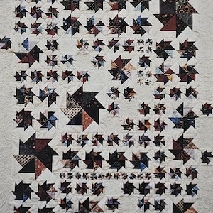 May include: A printed pattern titled "Pinwheel Patch" featuring a quilt design with numerous pinwheel shapes in various colors and patterns. The text "Item #502" is also visible. The pattern is from Cabin Fever Crafts.