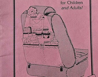 May include: A pink and white Kiddie Caddy Car Tote Pattern sewing pattern. The pattern includes instructions for making a car seat organizer with pockets for toys, snacks, and other items. The pattern is full-size and includes step-by-step illustrations. The pattern is for children and adults.