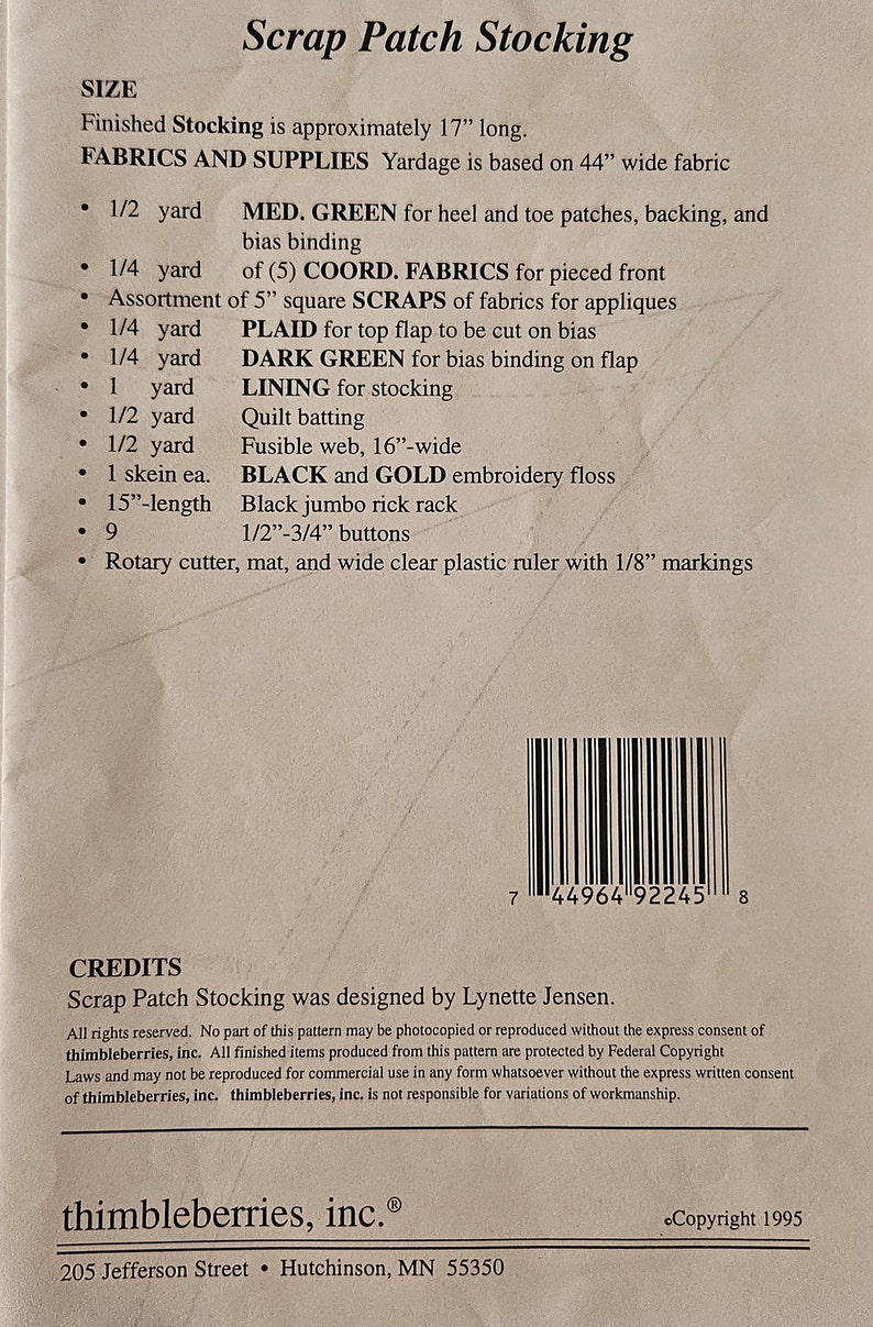 May include: A pattern for a scrap patch stocking, with a list of materials and supplies needed, including fabric, embroidery floss, buttons, and a rotary cutter. The pattern is designed by Lynette Jensen and is copyrighted by thimbleberries, inc.